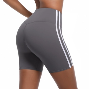 Detail view of high-waist grey yoga shorts with white side stripes and seamless stitching