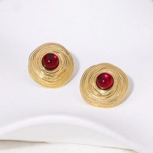 French vintage style gold spiral stud earrings with red gemstones on white base