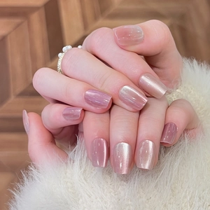 Pink cat eye gradient press-on nails in short square shape shown on hands