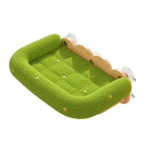 Green plush cat window hammock with wooden frame and yellow stars on white background