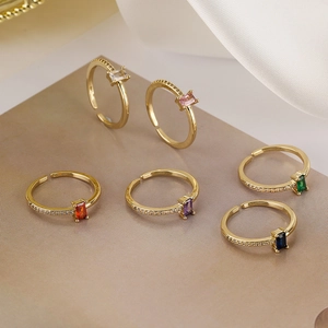 Detail view of multicolored zircon open rings in gold finish with rectangle gemstones