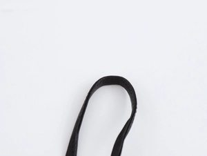 Close-up detail of the black sequined strap and fabric texture on a slim evening dress