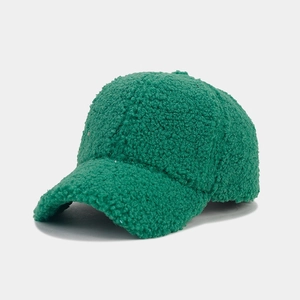 Detail of thick green lamb wool fabric texture on a warm winter baseball cap
