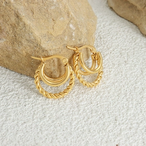 Classic 18K gold plated triple hoop earrings with twisted rope design on stone background
