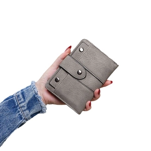 Fashionable grey leather wallet for women featuring vintage studs and a folding design