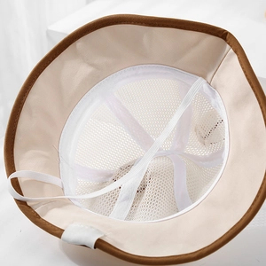 Detail view of baby sun hat showing breathable mesh lining and elastic windproof chin strap