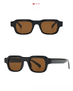 Detail view of square black frame sunglasses with tea lenses showing side temple structure