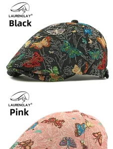 Detail of vintage jacquard beret hats featuring colorful butterfly patterns in pink and black