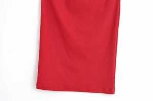 Dettaglio del vestito midi in maglia rossa che mostra la trama a coste e l'orlo