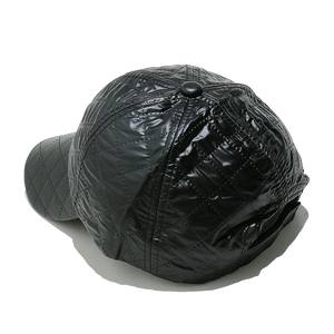 Detail view of the quilted diamond stitching and glossy fabric on the black baseball cap