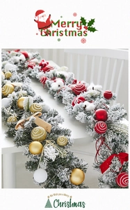 Detail of flocked Christmas garland with red bows, festive balls and cotton accents