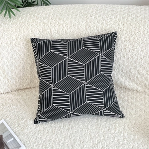Close-up of geometric black and white cube pattern on cotton linen pillow cover