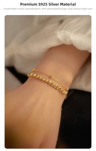 Macro detail of gold S925 silver double-layer bracelet showing faceted beads texture