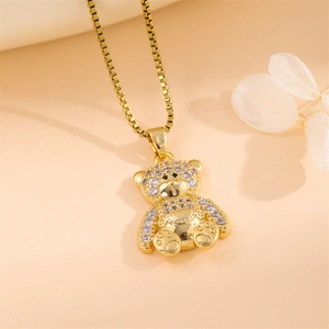 Cute golden teddy bear pendant necklace with sparkling zircons on a delicate box chain
