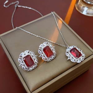 Détail d'un ensemble collier et boucles d'oreilles luxe avec gemme rouge et zircon