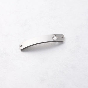 Detailed shot of a curved rectangular stainless steel connector with a flower cutout