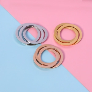 Detailed view of interconnected stainless steel rings in silver, gold and rose gold finish