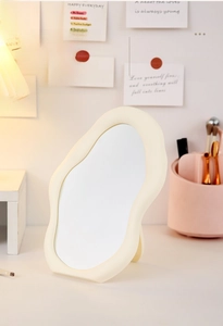 Close-up of cloud-shaped irregular makeup mirror with high-definition glass and cream frame