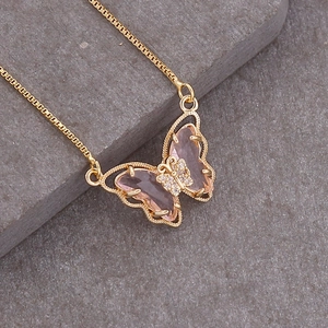 Elegant 18K gold butterfly necklace with pink crystal wings and crystal accents