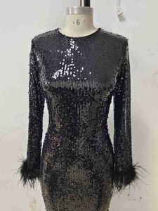 Detail of sequin evening dress featuring luxurious ostrich feather cuffs on long sleeves