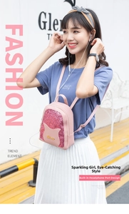 Detail of pink sequin mini backpack featuring cat ears and integrated headphone port
