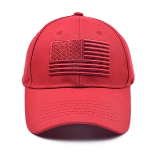 Close-up of red baseball cap featuring matching American flag embroidery on cotton twill
