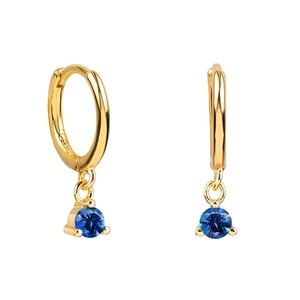 Close-up of gold hoop earrings with round blue zircon pendants in prong setting