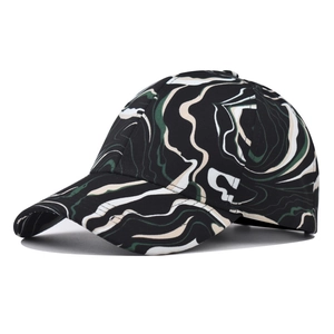 Detail of outdoor baseball cap featuring green and black fluid marble texture patterns