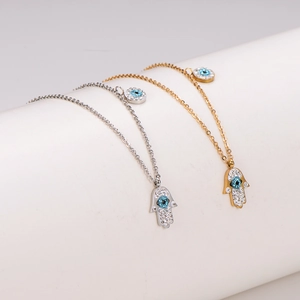 Gold and silver Hamsa Hand necklaces with blue Evil Eye pendant and sparkling rhinestones