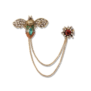 Vintage gold bee brooch with green rhinestones and floral chain double pin accessory