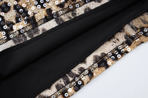 Detailed view of leopard print sequin dress hemline with black lining and stitching