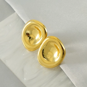 Detailed view of irregular 18k gold plated earrings on white ripple and silk