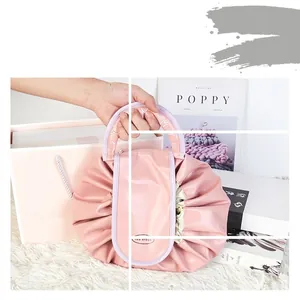 Pink drawstring cosmetic bag with silk-like fabric and tea break label for travel