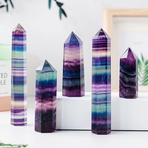 Natural rainbow fluorite hexagonal crystal pillars set in purple and green hues