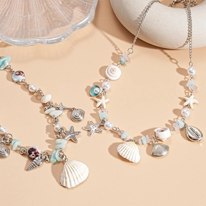 Silver beach necklace with pearls, starfish, and seashells for a summer coastal look