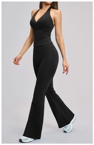 Black brushed yoga set featuring halter V-neck top and flared high-waisted leggings