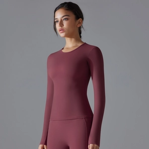 Close-up of slim fit burgundy long sleeve yoga top with high stretch fabric texture