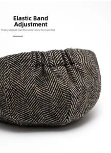 Detail view of tweed newsboy cap showing adjustable elastic band for size comfort
