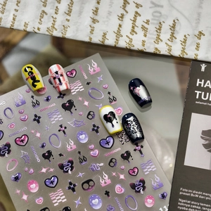 Cool gothic style nail art stickers with purple hearts, crosses, and silver glitter effects