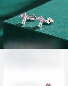 Macro detail of S925 sterling silver mushroom stud earring with hand-set pink zircons