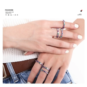 Close-up of titanium steel gold plated ring with rainbow colored cubic zirconia stones