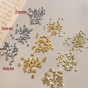 Macro view of gold and silver faceted square beads in sizes 2mm 3mm and 4mm