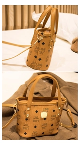 Close-up of monogrammed pebble leather handbag with gold hardware and side detail