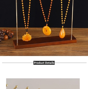 Detail view of amber resin pendants in rose, donut, and teardrop shapes on wooden stand