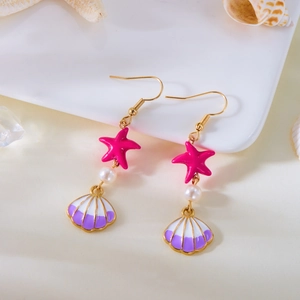 Detailed close-up of ocean earrings with starfish, white pearl, and purple shell