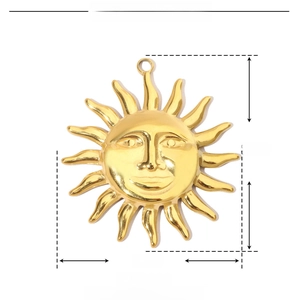 Detail shot of golden sun face pendant with 40mm height and 37mm width measurements