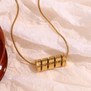 Close-up of 18K gold-plated stainless steel spiral spring pendant on a white background