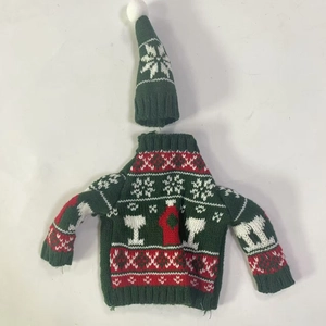 Detail of Christmas green knit bottle sweater and pointed hat with snowflake patterns