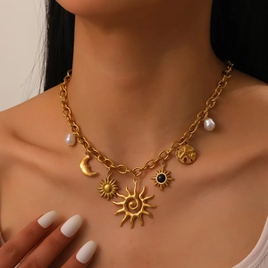Vue détaillée du collier plaqué or avec breloques soleil, lune, étoiles et perles