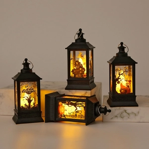 Macro shot of Halloween lanterns with ghost house, witch, and pumpkin silhouette patterns